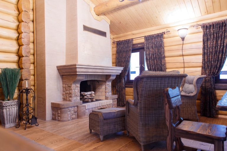 chimney room interior in private house built of logs.