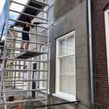 Vakkundige gevelreiniging op steiger voor een schoon en verzorgd resultaat.